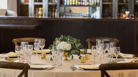 Elegant wedding table setting at Carlsbad Windmill Loft with gold chargers, glassware, and floral centerpiece.
