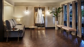 Carlsbad Windmill Garden Suite bridal room with wedding gown display and soft seating.