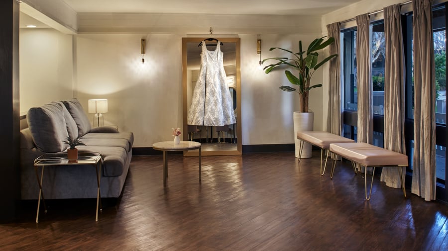 Carlsbad Windmill Garden Suite bridal room with wedding gown display and soft seating.