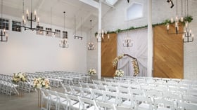 Carlsbad Windmill chapel decorated with soft florals and hexagon arch for wedding vows.