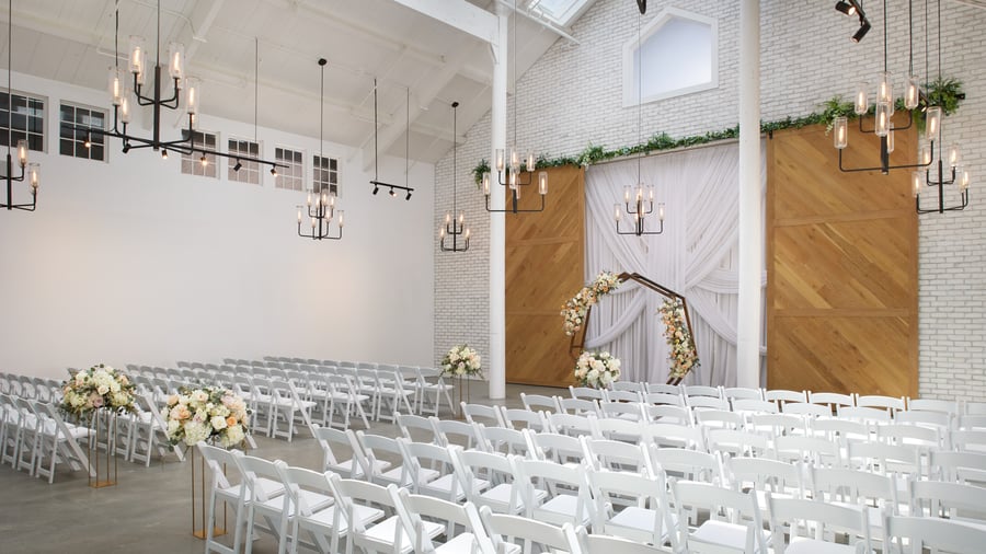 Carlsbad Windmill chapel decorated with soft florals and hexagon arch for wedding vows.