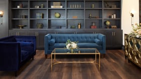 Carlsbad Windmill Loft lounge area with velvet seating, floral arrangements, and modern decor.