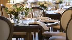 Sophisticated wedding table setting at Galway Downs with white floral centerpieces, crystal stemware, neutral linens, and elegant place settings for intimate receptions in Temecula, California