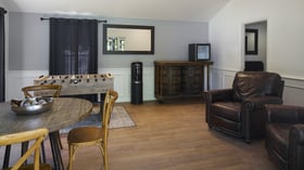 Fun entertainment room in Galway Downs Wedding Suites featuring foosball table, leather seating, rustic decor, and comfortable amenities for wedding party enjoyment in Temecula, California