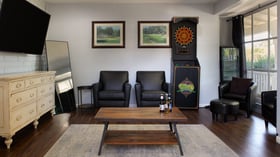 Groom’s lounge at Lindsay Grove in Mesa, AZ with leather chairs, dart board, rustic coffee table, and relaxed décor for getting ready.