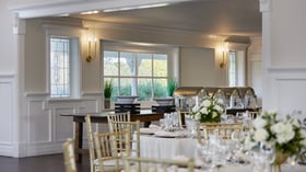 Wedding buffet and dining setup at Lindsay Grove Grand Hall in Mesa, AZ with banquet tables, gold chairs, and floral arrangements.