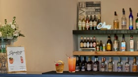 Scenic Springs wedding bar in Helotes, Texas, featuring signature drinks, floral arrangements, and a stocked back bar.