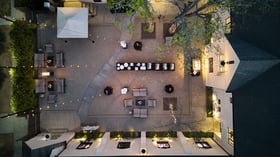 Aerial view of The Sanctuary courtyard in Long Beach set for a wedding cocktail hour with lounge seating and string lights.
