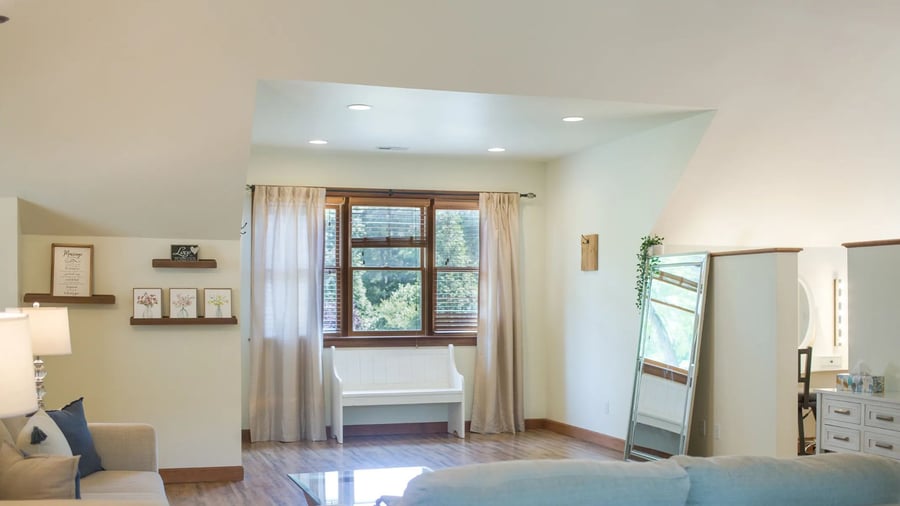 Bright, airy bridal suite with window seat and full-length mirror at Alexander Homestead wedding venue in Charlotte, NC