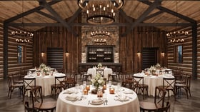 Log Cabin Style Banquet Hall at Casa del Rio Fresno - Rustic Log Cabin Interior with Stone Bar and Chandeliers