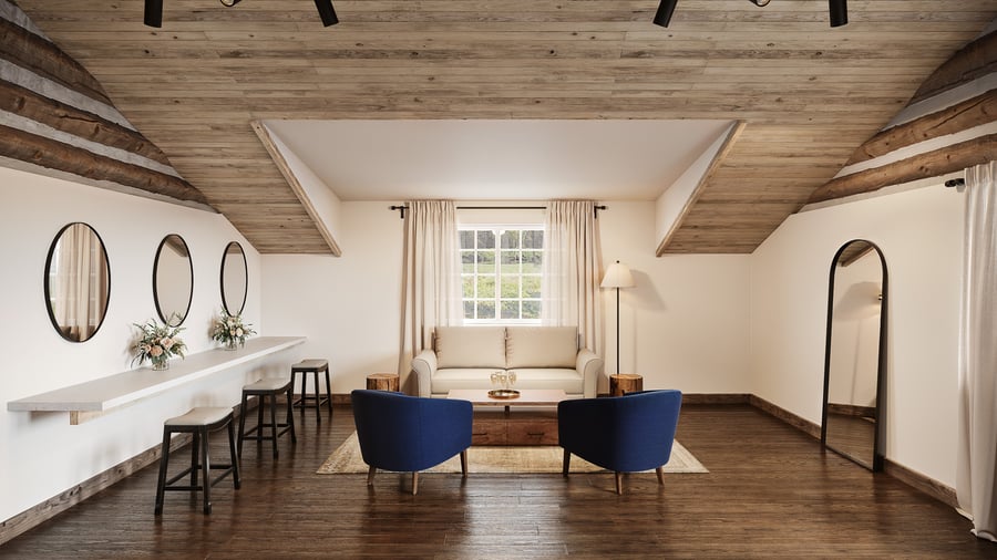 Bright preparation suite at Casa del Rio Fresno featuring wooden beam ceiling, white walls, built-in vanity with three oval mirrors, cream loveseat, navy blue accent chairs, wooden coffee table, and full-length mirror in a rustic-modern design.