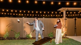 Guests playing corn hole - Canopy Grove by Wedgewood Events