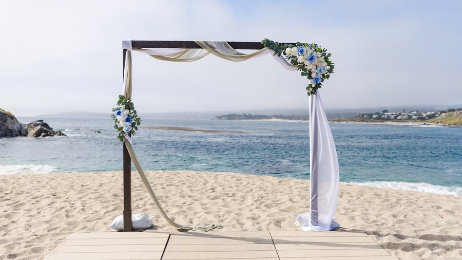 Arch with drapery and florals at beach - Carmel Fields by Wedgewood Events