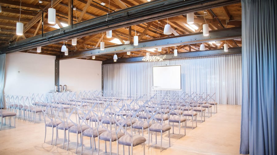 Corporate presentation in The Rafters at Clayton House with grey draping and industrial style architecture