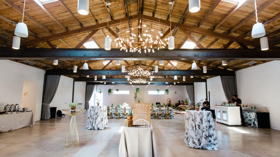 Exposed beams, polished concrete floors, and sun lights provide a chic networking space in The Rafters at Clayton House