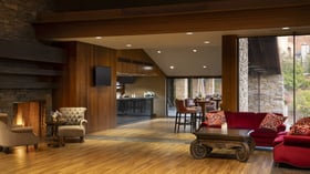 Inviting great room with soaring ceilings, rich wood architectural details, and versatile open-concept design - perfect for pre-function gatherings and small cocktail receptions with seamless indoor-outdoor flow