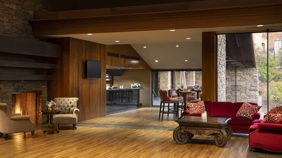 Inviting great room with soaring ceilings, rich wood architectural details, and versatile open-concept design - perfect for pre-function gatherings and small cocktail receptions with seamless indoor-outdoor flow