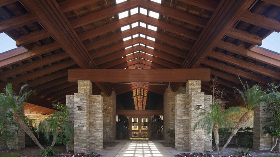 Serene outdoor ceremony site with majestic oak canopy and mountain backdrop, arranged for an intimate wedding celebration with natural beauty as the centerpiece