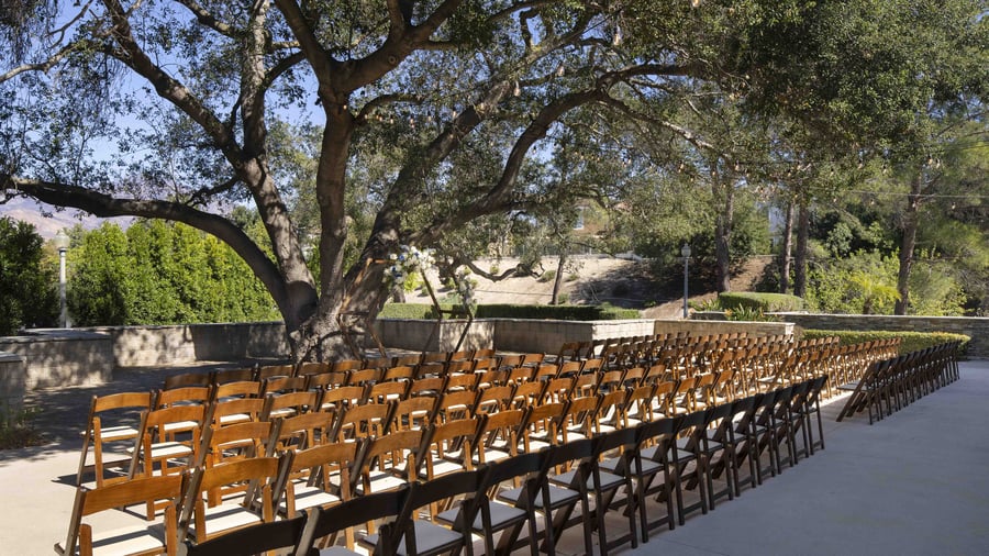 Elegantly appointed private lounge with designer drapery, classic wall paneling, and chic seating areas - providing versatile pre-function spaces for the wedding party