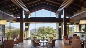 Sophisticated mountain view lounge with comfortable seating clusters, massive picture windows, and breathtaking panoramic hillside views, offering the perfect space for pre-wedding gatherings and intimate conversations