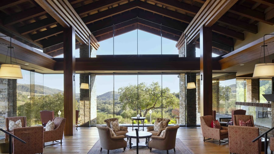 Sophisticated mountain view lounge with comfortable seating clusters, massive picture windows, and breathtaking panoramic hillside views, offering the perfect space for pre-wedding gatherings and intimate conversations