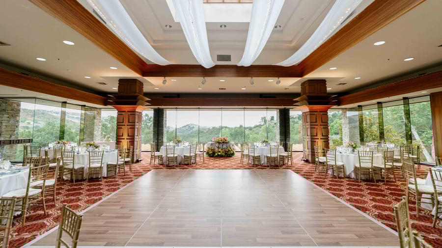 Mid-century modern style grand hall with wood dance floor at Dove Canyon by Wedgewood Events
