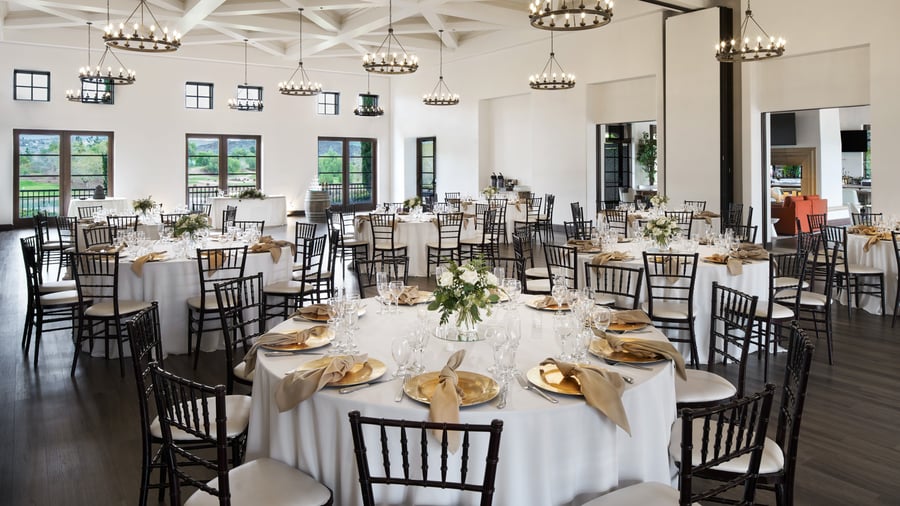 Spacious event reception ballroom at Fallbrook Estate Wedgewood Events with coffered ceiling, wrought iron chandeliers, round tables and garden views for large corporate events and private celebrations