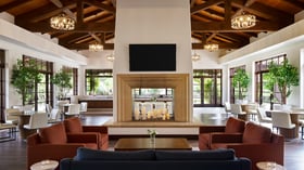 Contemporary event reception lounge at Fallbrook Estate featuring exposed wood beams, geometric chandeliers, modern furniture, two-way fireplace and floor-to-ceiling windows for corporate events and private parties