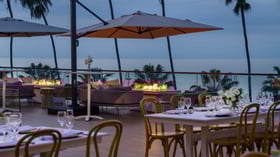 Lounge seating with fire features and umbrellas overlooking coastline
