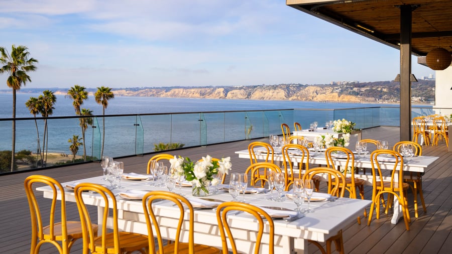  Long dining tables with ocean views and elegant place settings