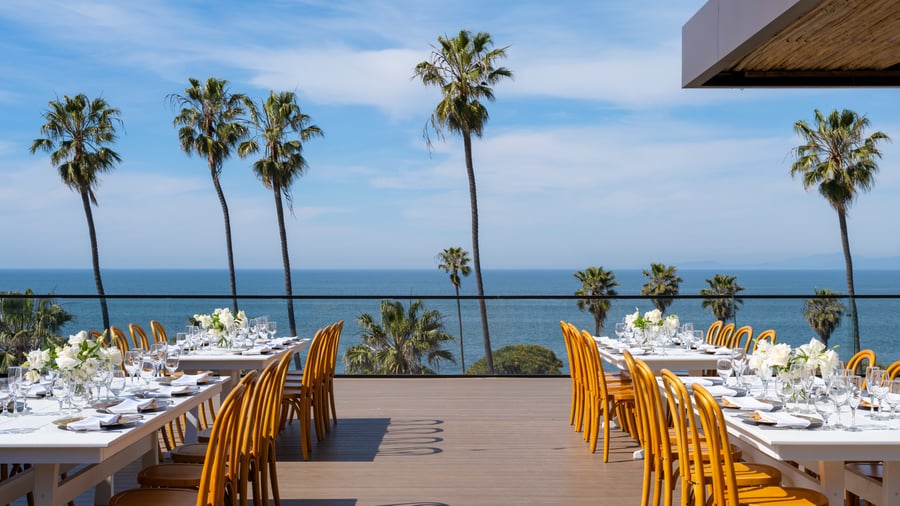  Wedding reception tables with ocean backdrop and palm trees