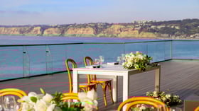  Intimate dining table for two with white flowers and ocean panorama