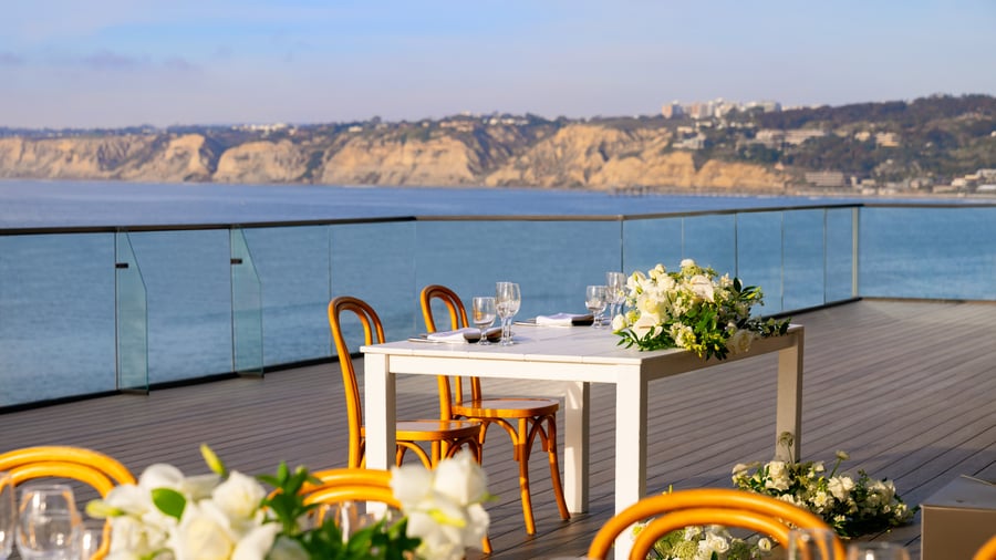  Intimate dining table for two with white flowers and ocean panorama
