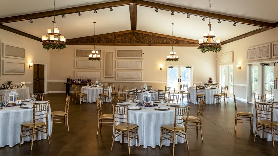 Beautifully decorated reception tables at Riverwood Manor's Grand Hall featuring white linens and gold chiavari chairs, perfect for fundraisers, galas, and corporate dinners