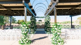Patio ceremony with flowers - Stallion Mountain by Wedgewood Events