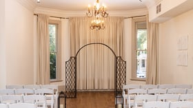 Indoor ceremony site with draping and chandeliers - Sterling Hotel by Wedgewood Events