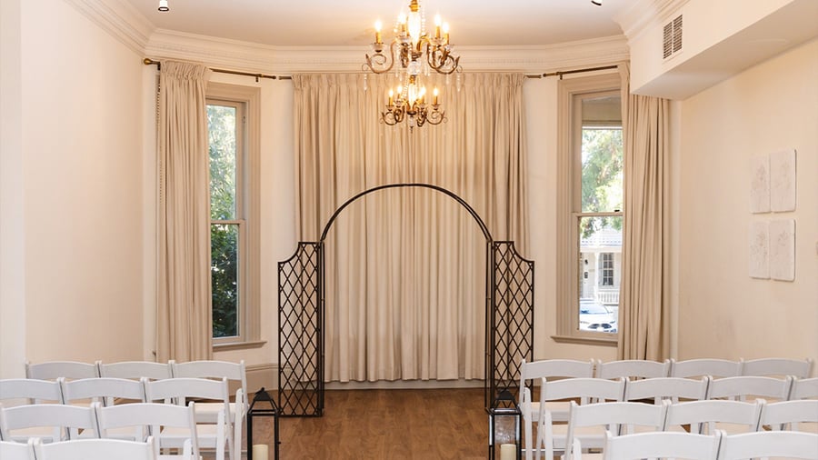 Indoor ceremony site with draping and chandeliers - Sterling Hotel by Wedgewood Events