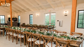 Napa table reception space with greenery and cross back chairs - Canopy Grove by Wedgewood Events
