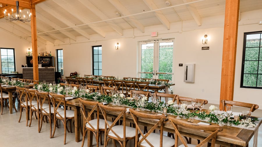 Napa table reception space with greenery and cross back chairs - Canopy Grove by Wedgewood Events